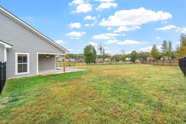 a view of yard with swimming pool and green space