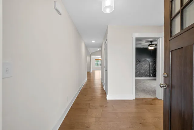 a view of hallway with wooden floor