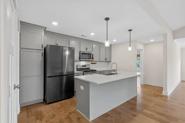 a kitchen with a refrigerator a sink and a oven