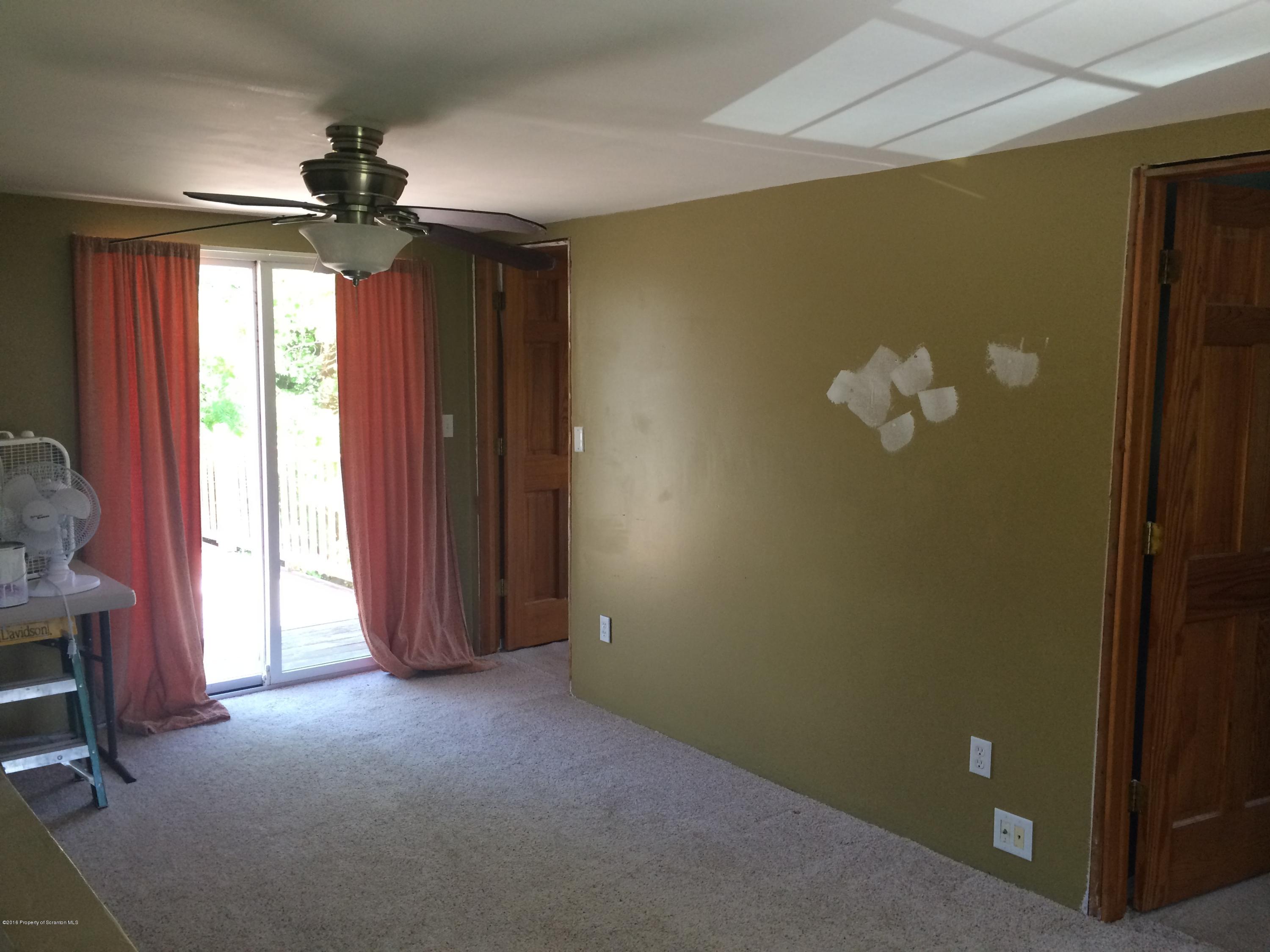 568 Cortez Road Lake Ariel, PA 18436 - Photo 14 of 17 a view of empty room with a fireplace and fan