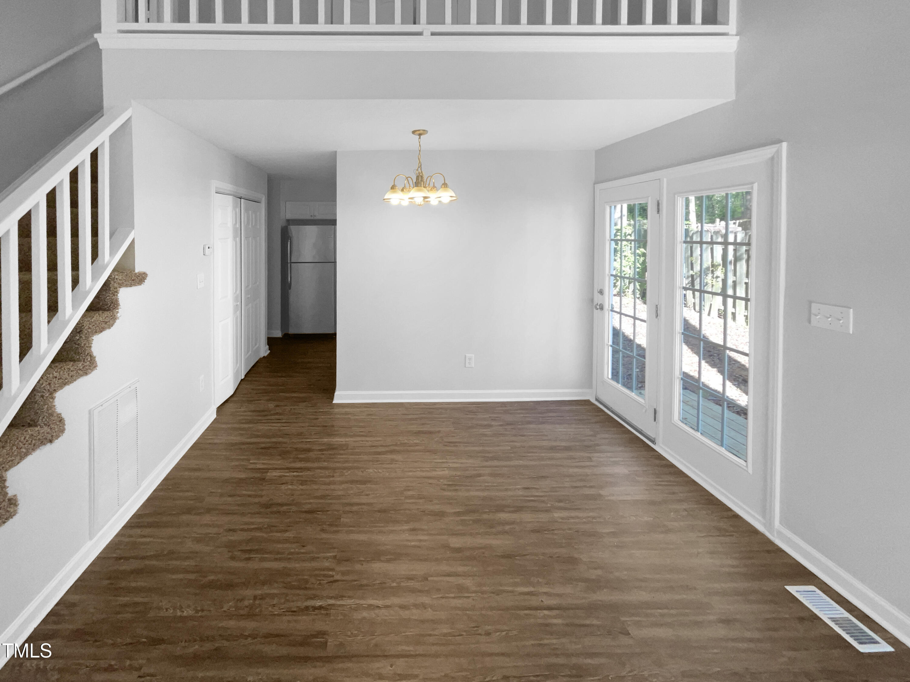 720 Rawls Drive Raleigh, NC 27610 - Photo 3 of 17 a view of an empty room with wooden floor and a window