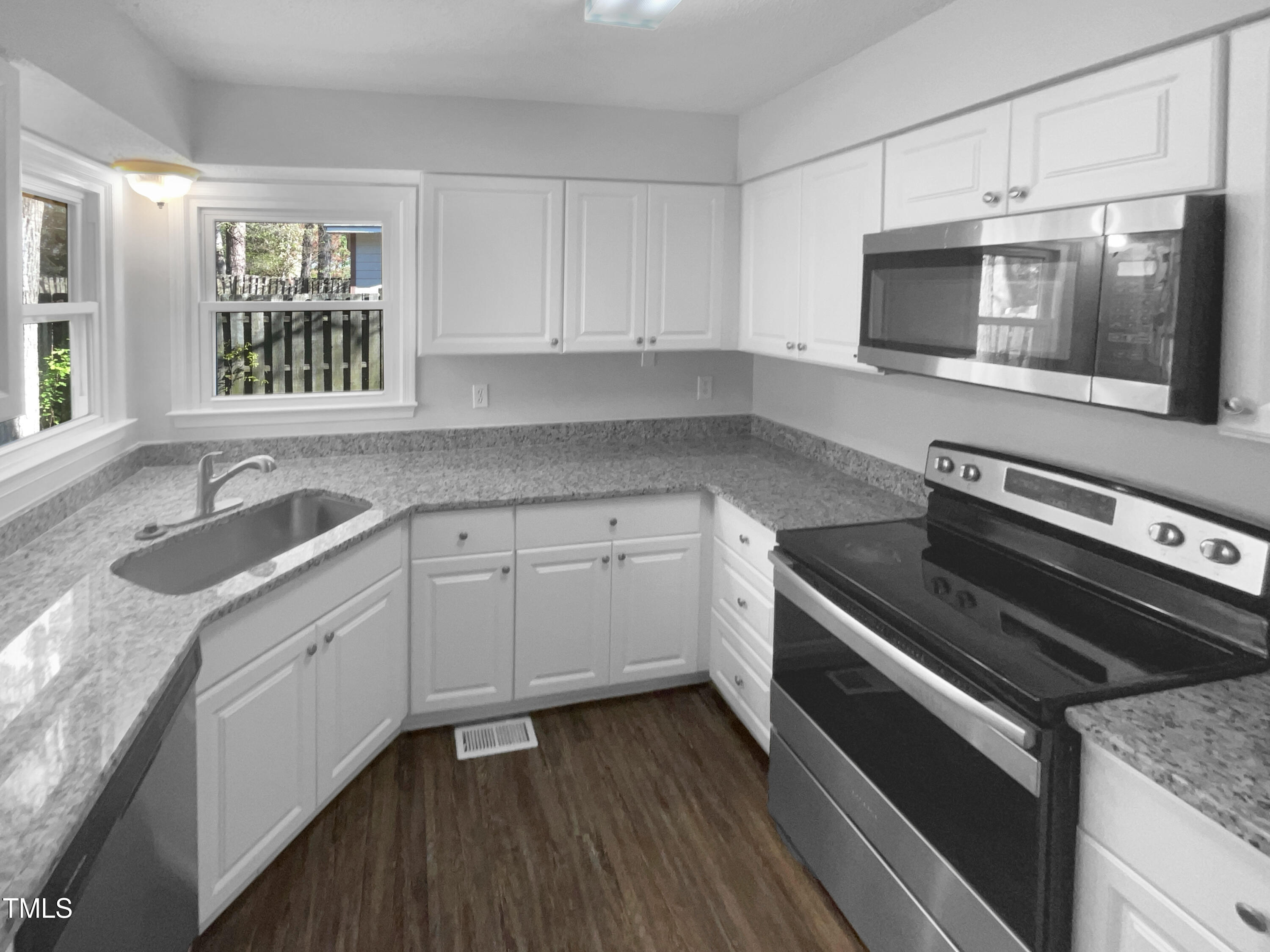 720 Rawls Drive Raleigh, NC 27610 - Photo 8 of 17 a kitchen with a sink stove and microwave