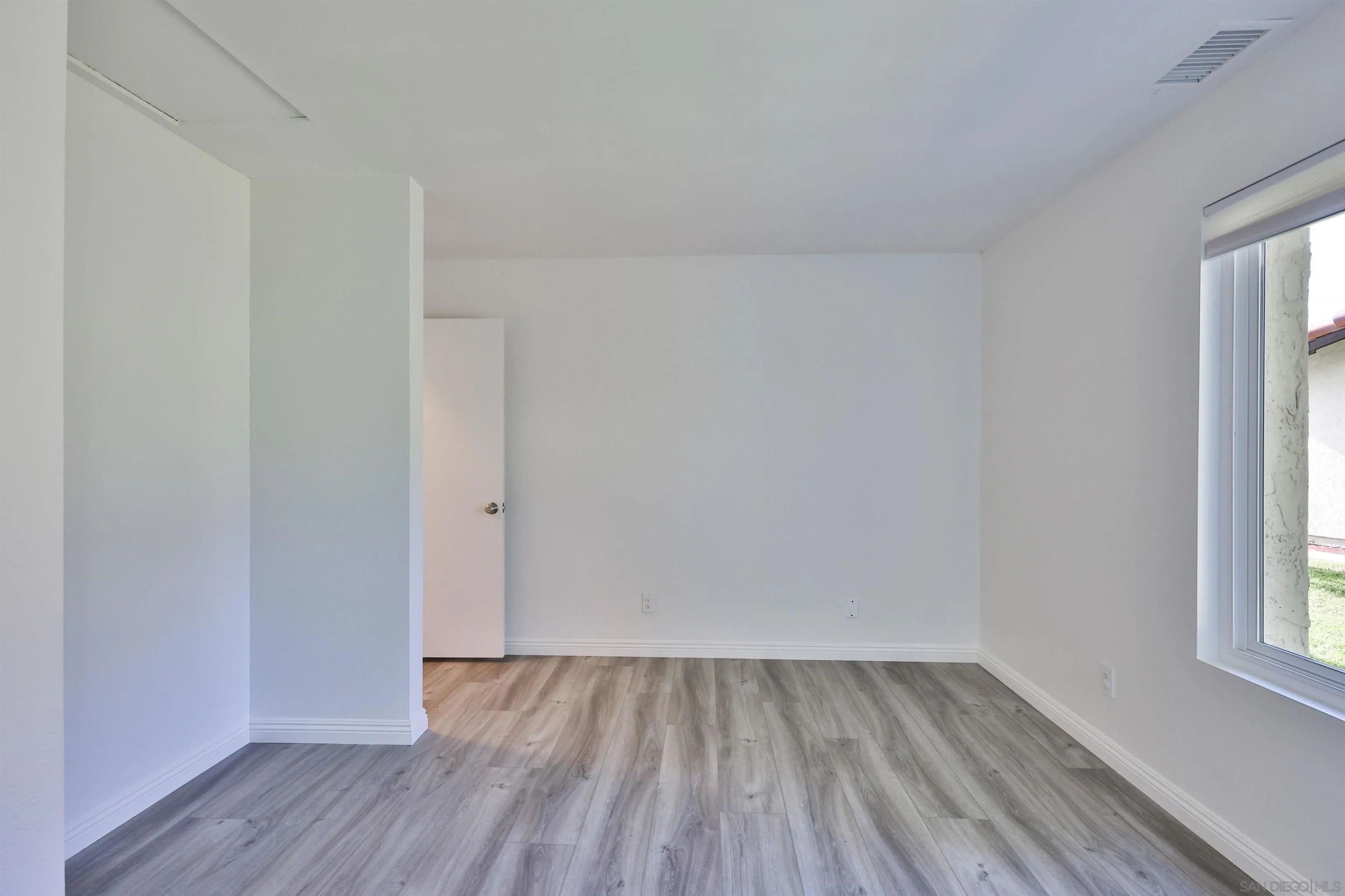 1732 Belle Meade Road Encinitas, CA 92024 - Photo 24 of 37 an empty room with wooden floor and windows