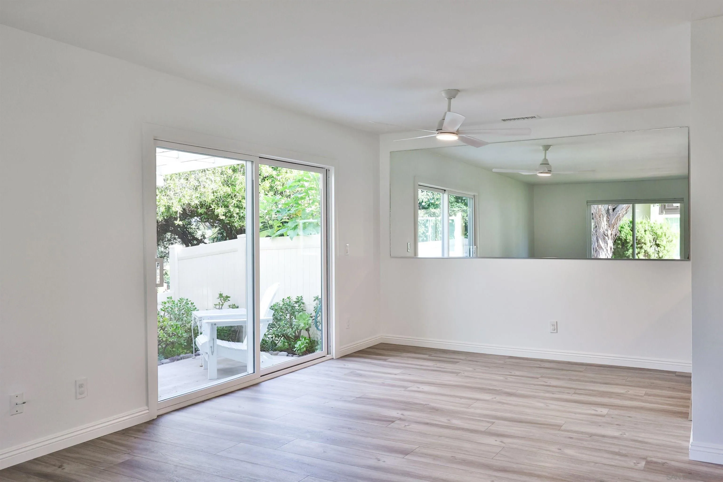 1732 Belle Meade Road Encinitas, CA 92024 - Photo 5 of 37 an empty room with wooden floor and windows