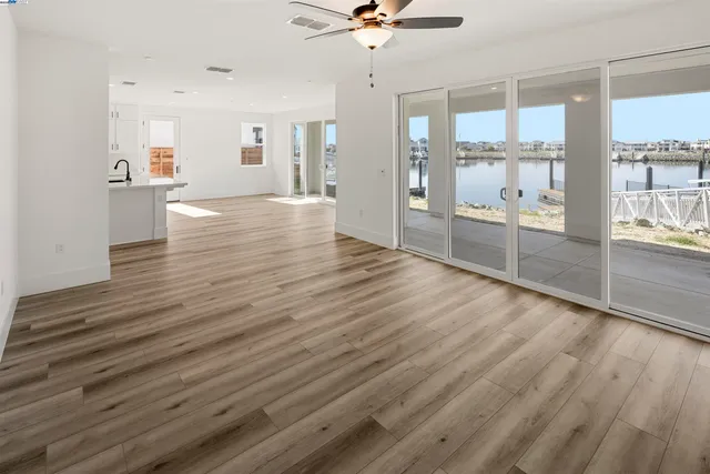 a view of a kitchen with wooden floor and a kitchen space
