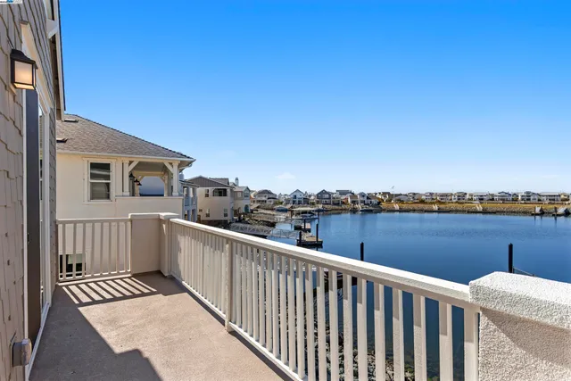 a view of a balcony with wooden floor and city view