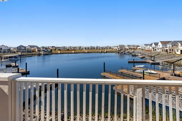 a view of open kitchen with a large window and refrigerator