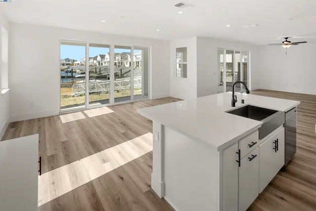 a kitchen with sink and view of living room