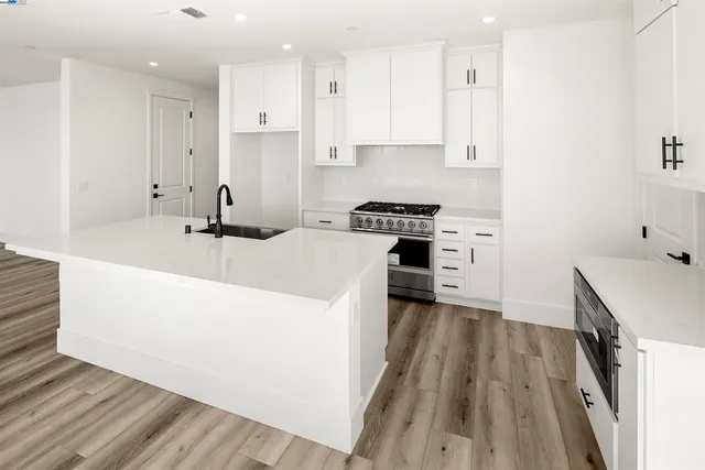 a kitchen with a sink a stove and a refrigerator