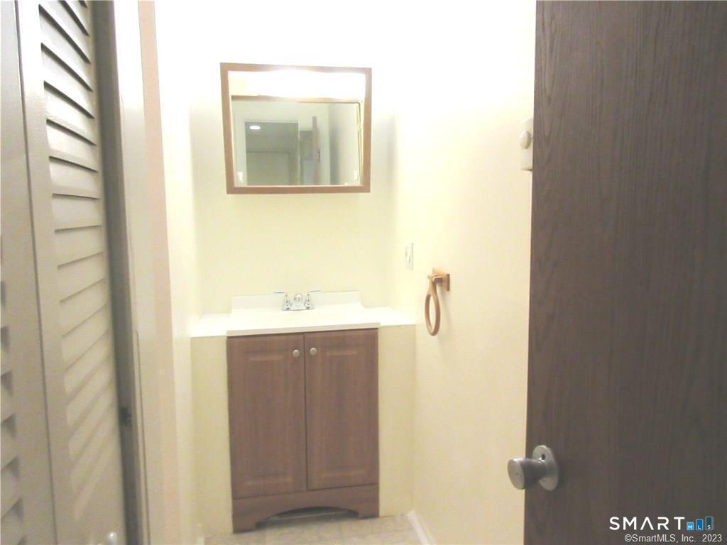 5 Nabby Road, Unit A17 Danbury, CT 06811 - Photo 7 of 11 a bathroom with a sink and mirror