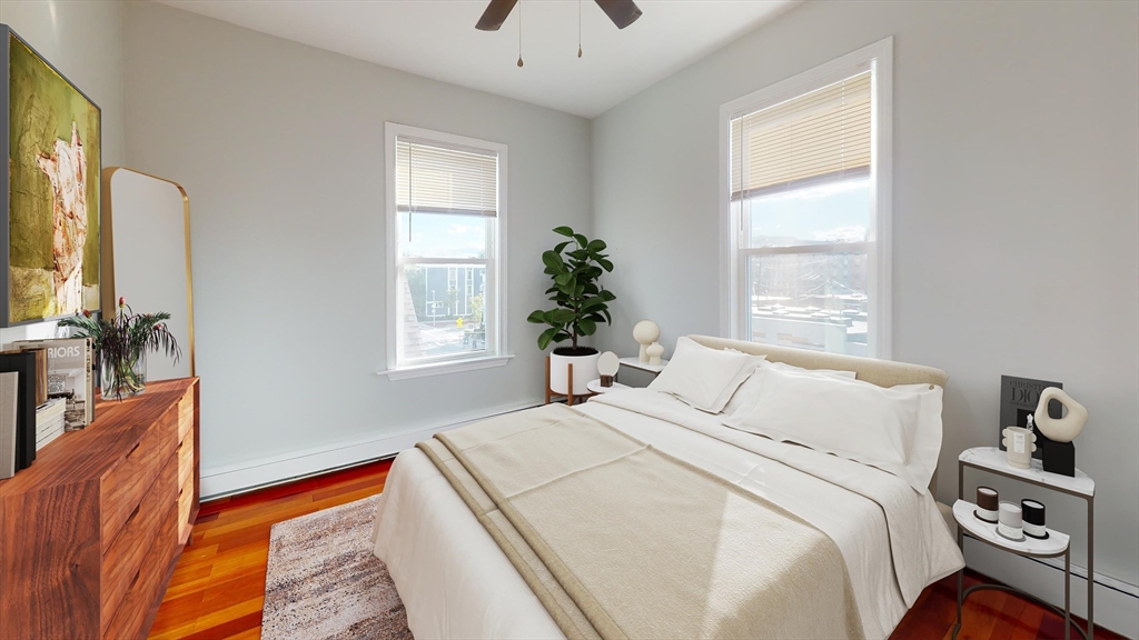 108 Boston Street, Unit 2 Boston, MA 02125 - Photo 3 of 10 a bedroom with a bed and a chandelier