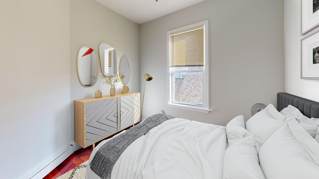 108 Boston Street, Unit 2 Boston, MA 02125 - Photo 4 of 10 a bedroom with a bed and a window
