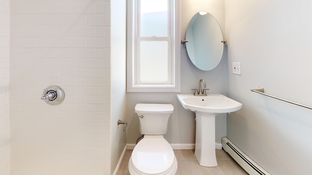 108 Boston Street, Unit 2 Boston, MA 02125 - Photo 6 of 10 a bathroom with a sink toilet and a mirror