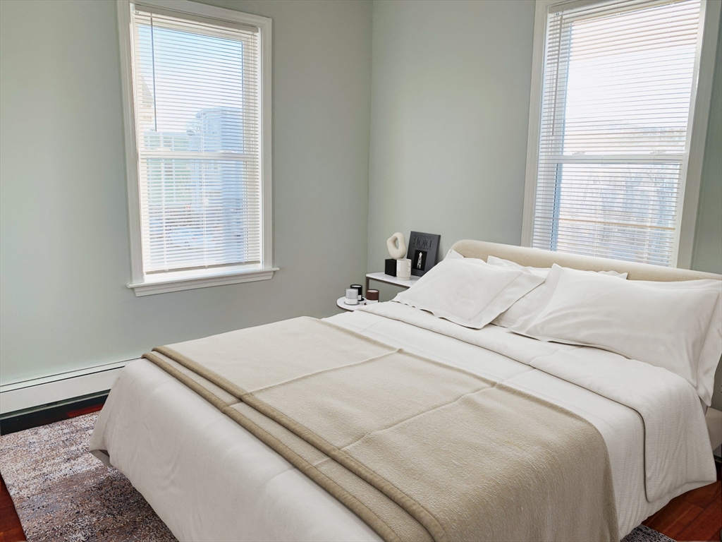 108 Boston Street, Unit 2 Boston, MA 02125 - Photo 8 of 10 a bedroom with a bed and a window