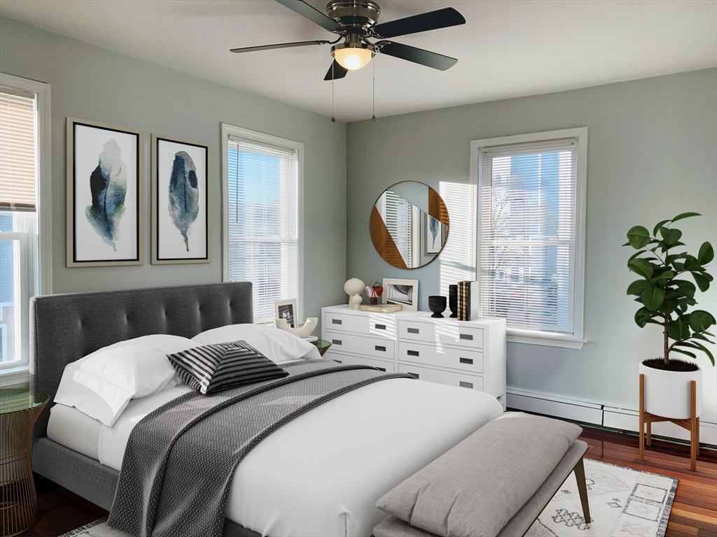 108 Boston Street, Unit 2 Boston, MA 02125 - Photo 9 of 10 a bedroom with a bed and a chandelier
