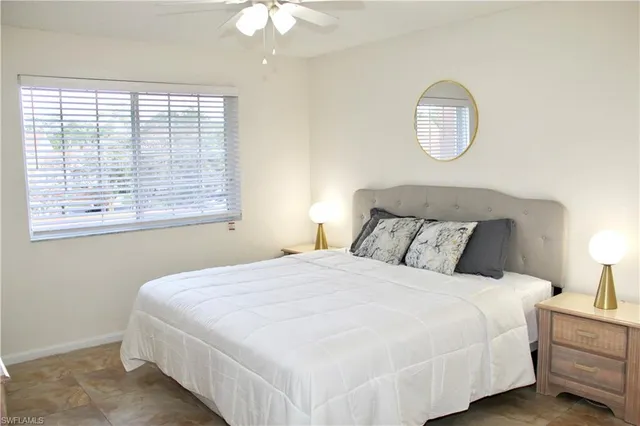 a bedroom with bed and a window