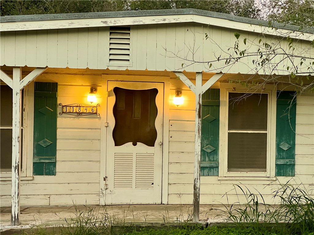11846 Up River Road Corpus Christi, TX 78410 - Photo 3 of 4 a front view of a house with a glass door