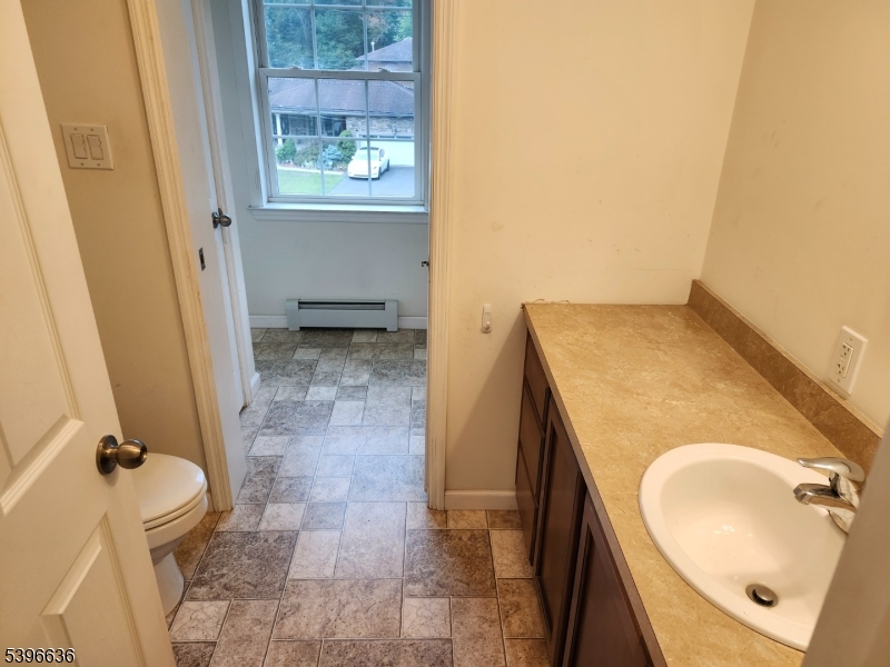 128 Big Piece Road Fairfield, NJ 07004 - Photo 13 of 22 a bathroom with a sink and a mirror