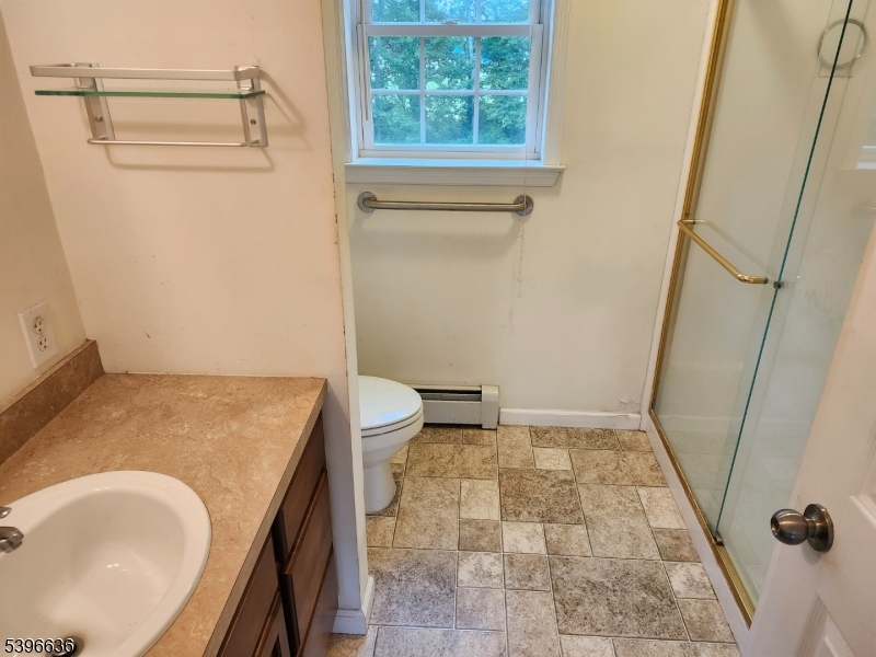 128 Big Piece Road Fairfield, NJ 07004 - Photo 17 of 22 a bath room with a sink and a toilet