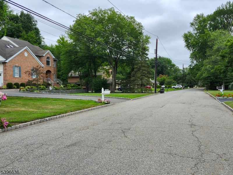 128 Big Piece Road Fairfield, NJ 07004 - Photo 2 of 22 a view of a house with a big yard and large trees