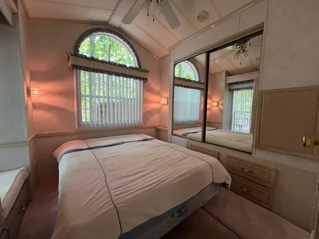 a bedroom with a bed and a window