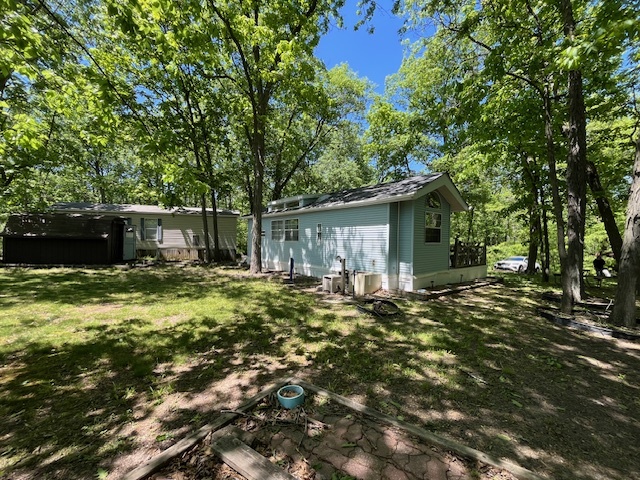 2795 East 28th Road Marseilles, IL 61341 - Photo 2 of 59 a backyard of a house with table and chairs under an umbrella