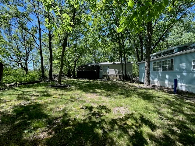 a view of a backyard with large trees