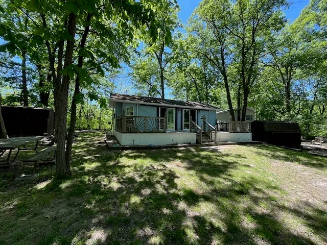 a view of a house with backyard and sitting area