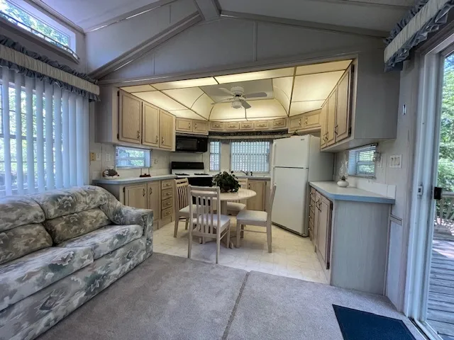 a kitchen with stainless steel appliances granite countertop a dining table and chairs