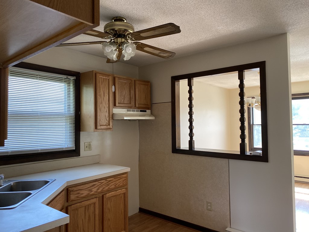 218-220 Centre Street Springfield, MA 01151 - Photo 20 of 27 a kitchen with a window a sink and a mirror