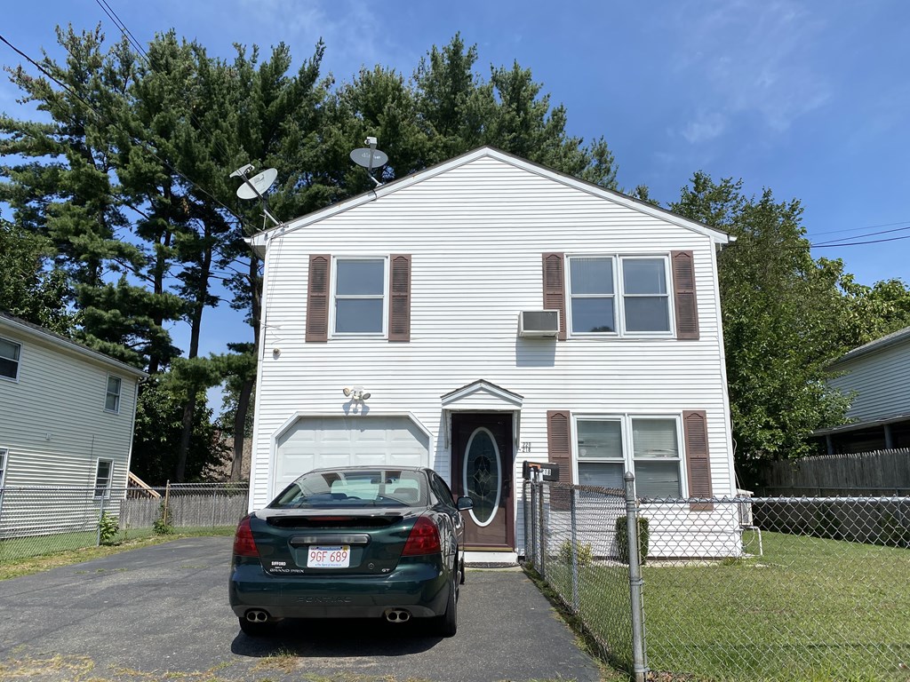 218-220 Centre Street Springfield, MA 01151 - Photo 3 of 27 a car parked in front of a house