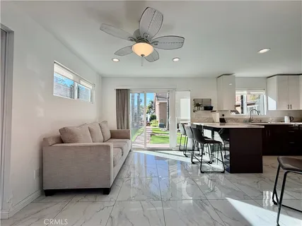 a living room with lots of furniture and a large window