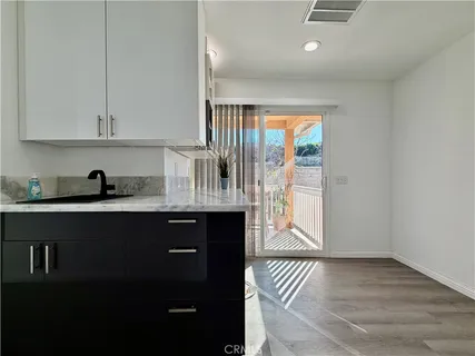 a kitchen with kitchen island a counter top space a sink and a refrigerator