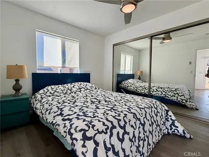 a large bed sitting in a bedroom next to a window