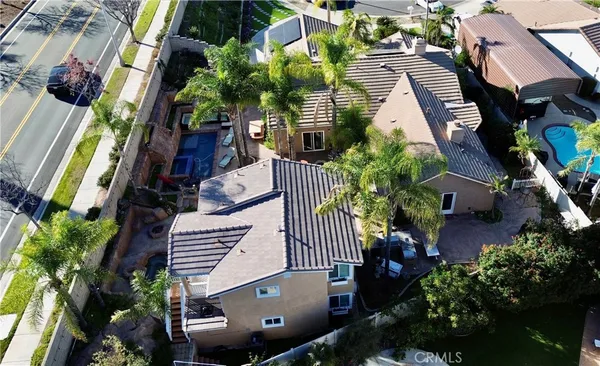 an aerial view of multiple houses with yard