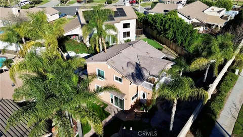an aerial view of multiple houses with a yard