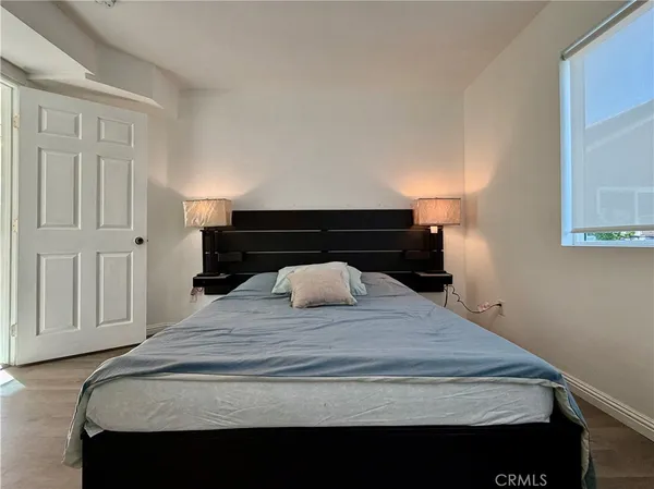 a bedroom with a bed and a night stand