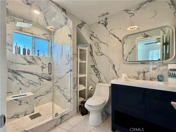 a bathroom with a toilet sink and shower