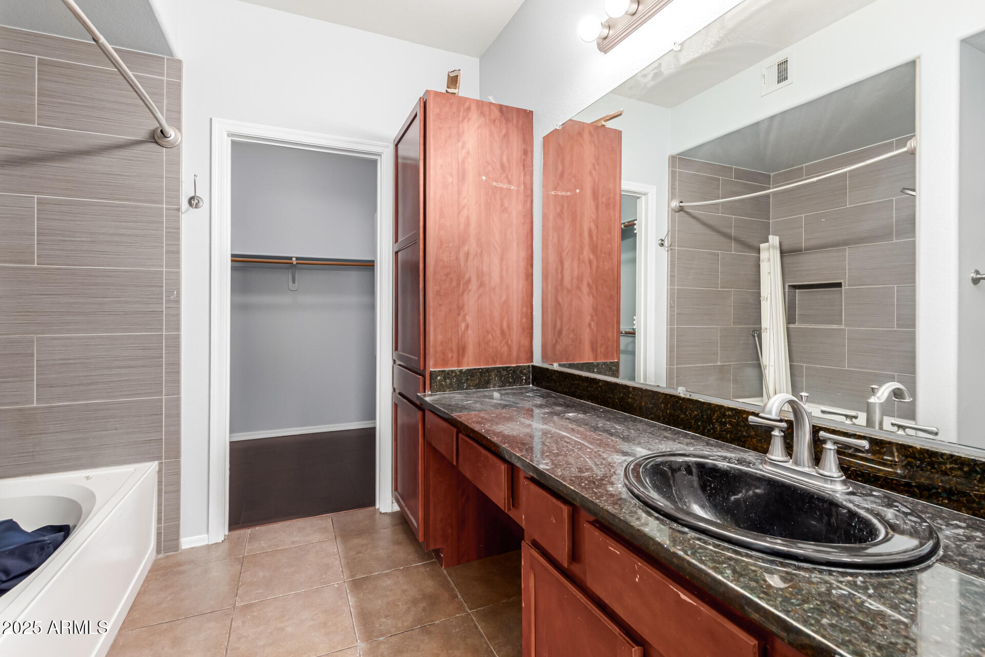 3302 North 7th Street, Unit 225 Phoenix, AZ 85014 - Photo 11 of 23 a bathroom with a granite countertop sink and a mirror