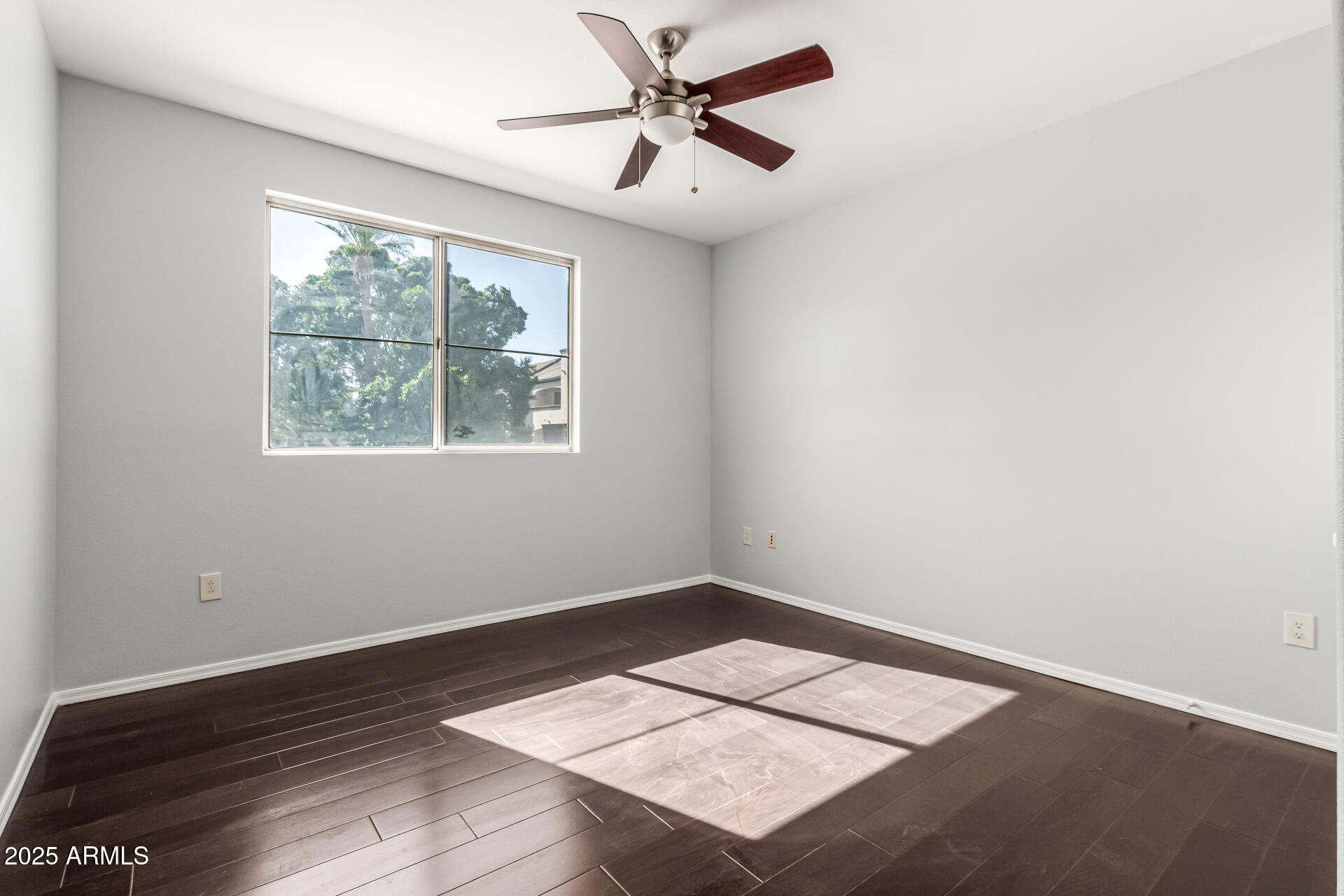 3302 North 7th Street, Unit 225 Phoenix, AZ 85014 - Photo 13 of 23 an empty room with wooden floor and windows