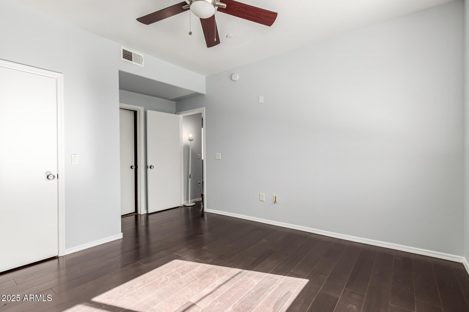 3302 North 7th Street, Unit 225 Phoenix, AZ 85014 - Photo 14 of 23 an empty room with wooden floor and ceiling fan