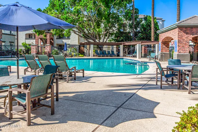 a view of house with swimming pool outdoor seating area