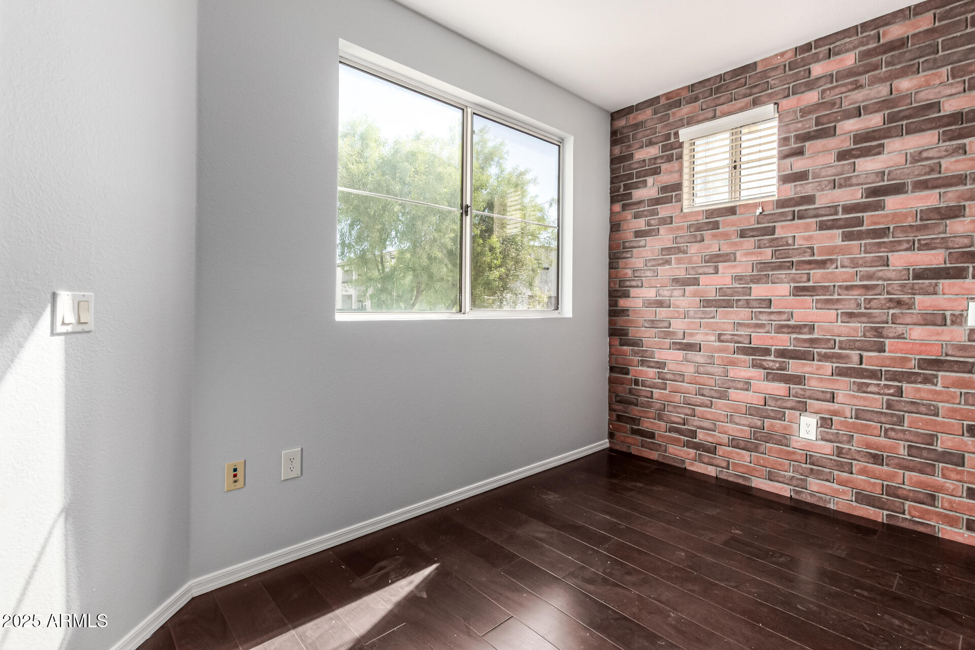 3302 North 7th Street, Unit 225 Phoenix, AZ 85014 - Photo 6 of 23 a view of an empty room with wooden floor and a window