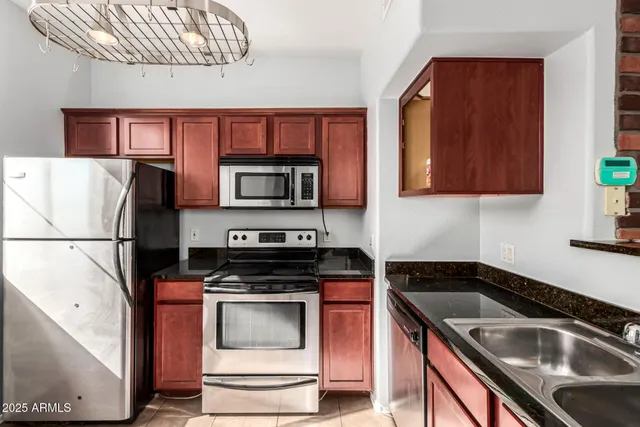 a kitchen with a sink cabinets and stainless steel appliances