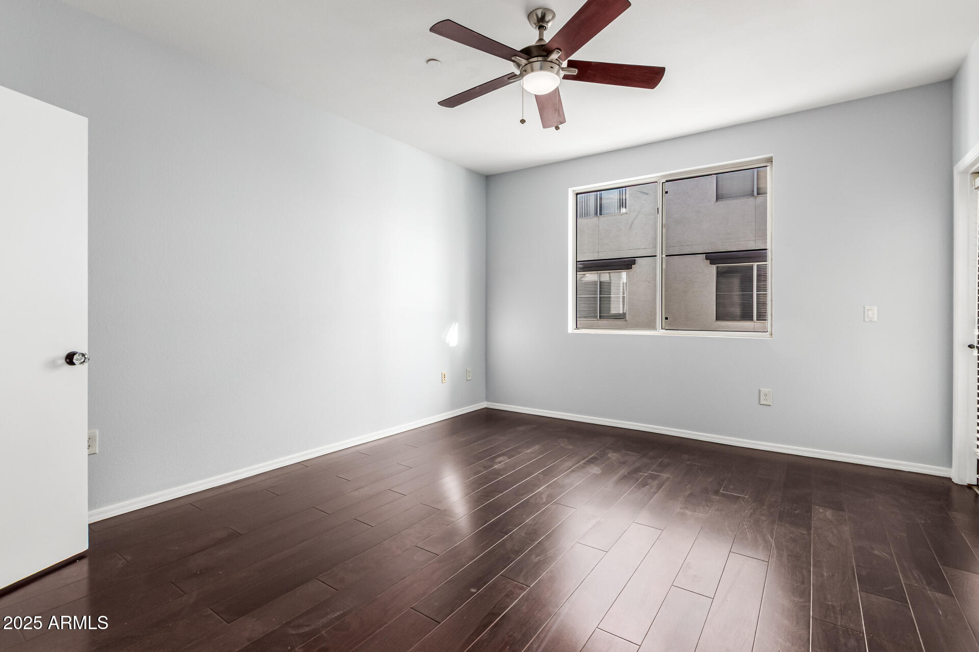 3302 North 7th Street, Unit 225 Phoenix, AZ 85014 - Photo 9 of 23 an empty room with wooden floor fan and windows