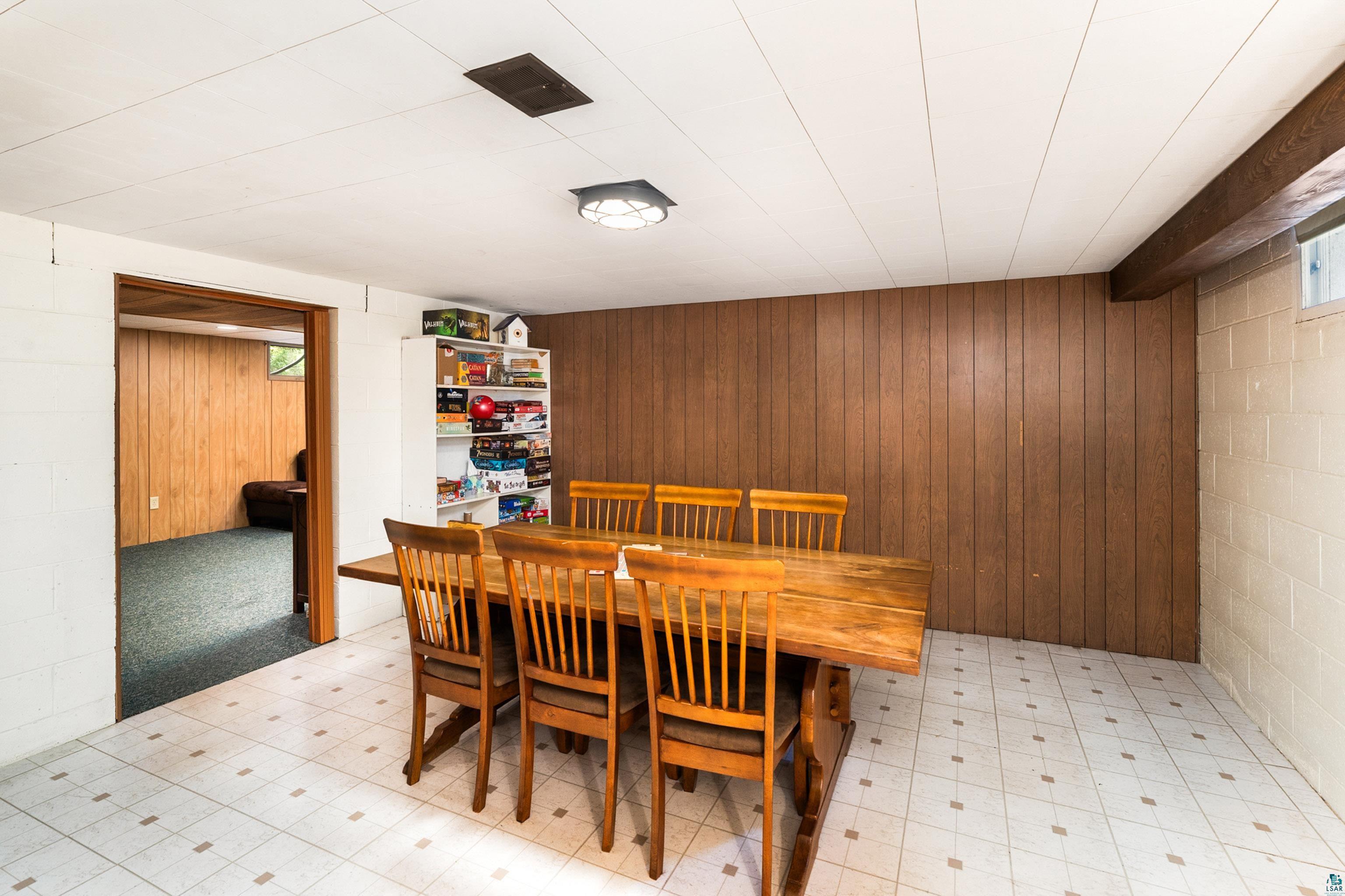 4808 Midway Road Duluth, MN 55811 - Photo 37 of 57 Bright room featuring a wood-finish accent wall and a white block wall