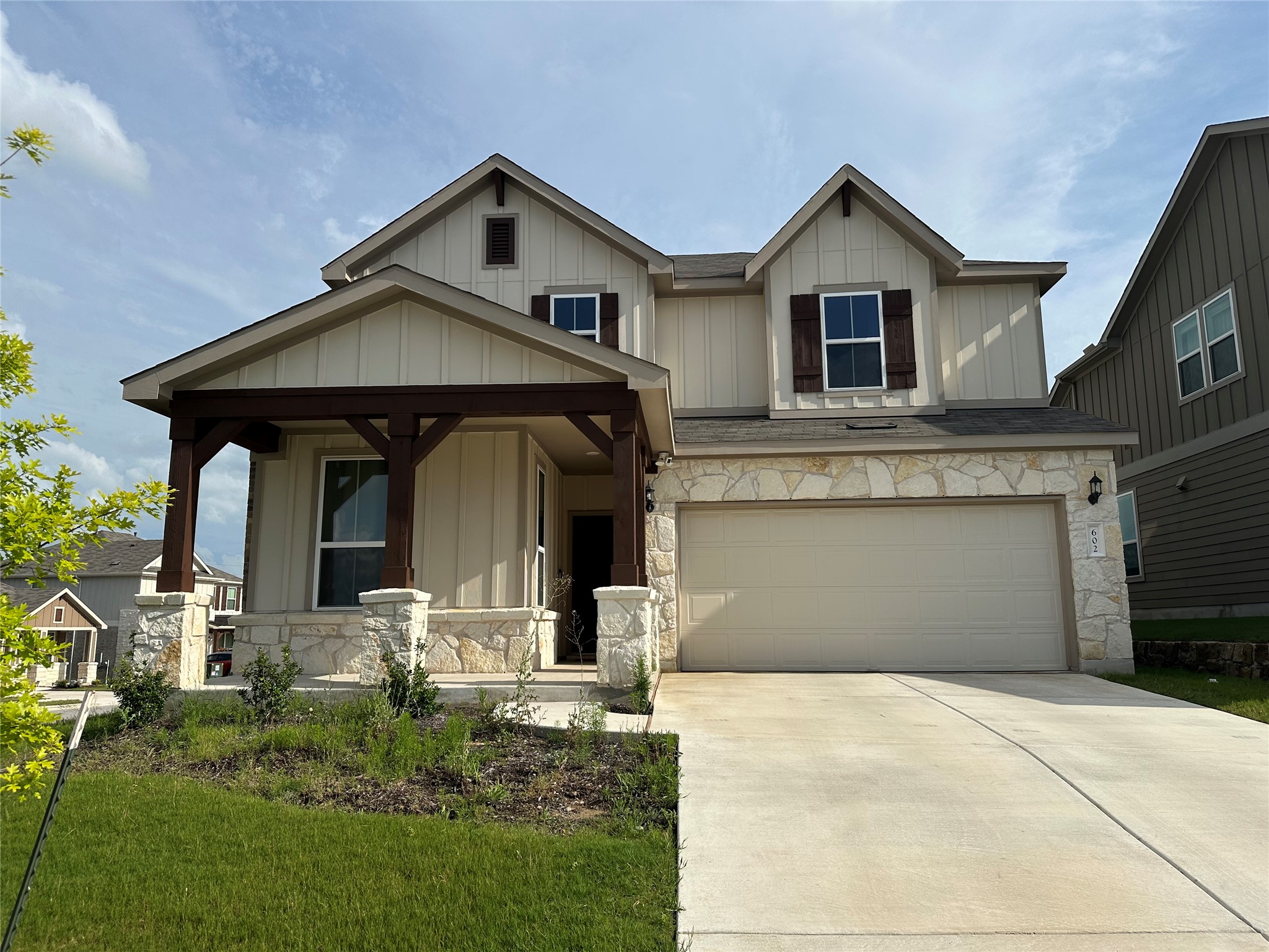 602 Tree Nut Loop Buda, TX 78610 - Photo 1 of 1 Crafted with board and batten siding and stone accents, this charming home features a welcoming covered entry.