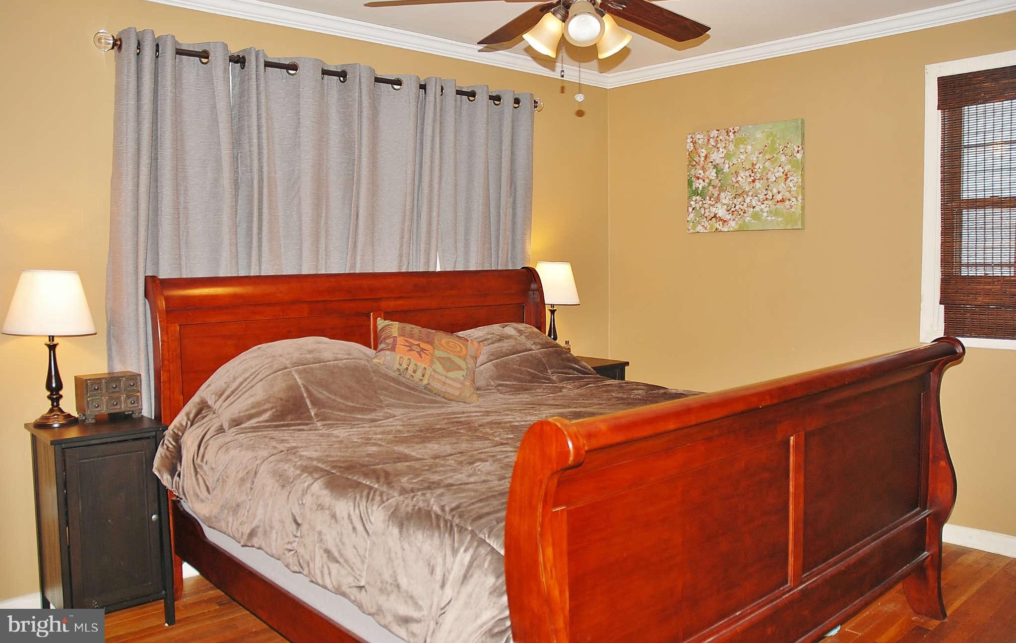 4100 Delancy Drive Silver Spring, MD 20906 - Photo 7 of 20 a bed sitting in a bedroom next to a lamp