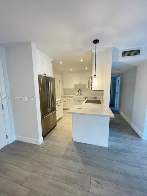 Glenvar Heights Miami, FL 33143 - Photo 3 of 14 a view of kitchen with refrigerator stove and wooden floor