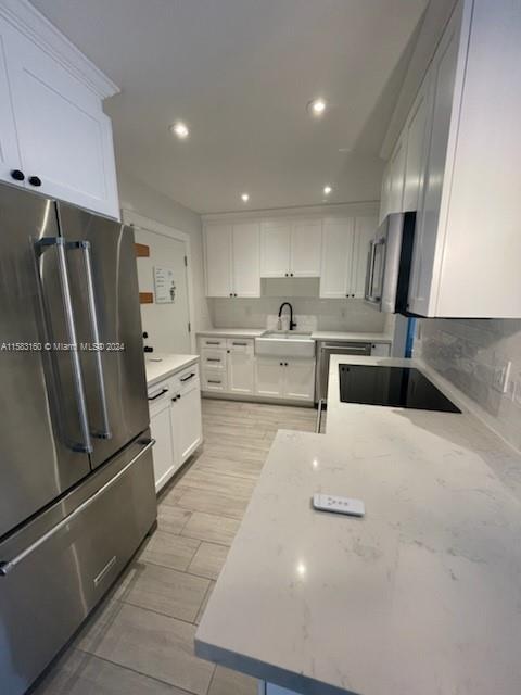 Glenvar Heights Miami, FL 33143 - Photo 4 of 14 a kitchen with stainless steel appliances a refrigerator sink and cabinets